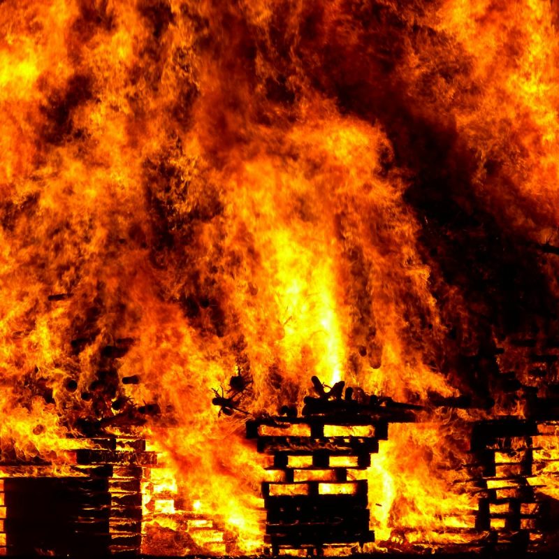 Intense flames engulf wooden pallets in a breathtaking display of fire and heat.